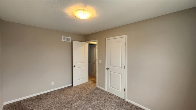 unfurnished bedroom with light colored carpet