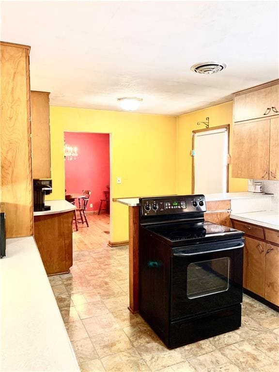 kitchen featuring kitchen peninsula and black / electric stove