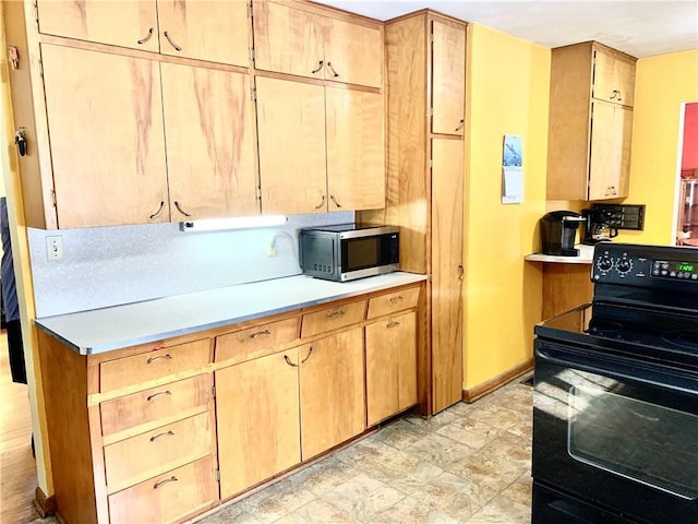 kitchen with light brown cabinets and black electric range oven