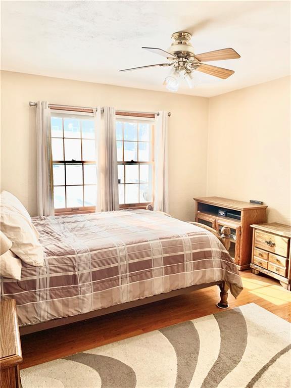 bedroom featuring ceiling fan and light hardwood / wood-style flooring