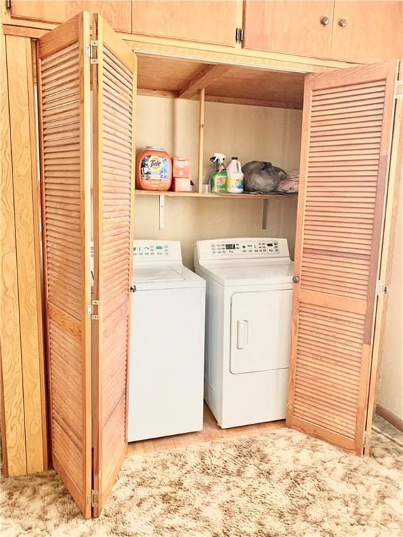 clothes washing area with washing machine and clothes dryer