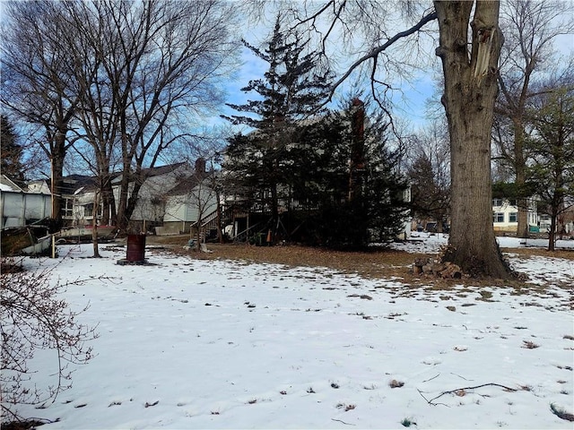 snowy yard featuring stairs