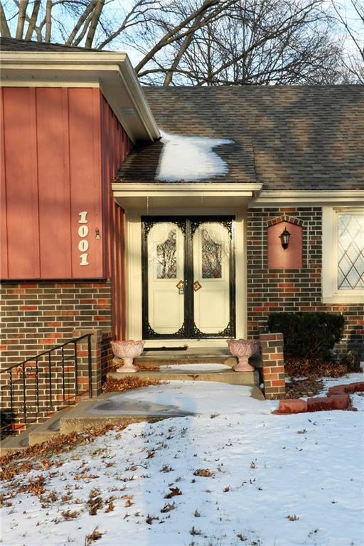 snow covered property entrance featuring french doors