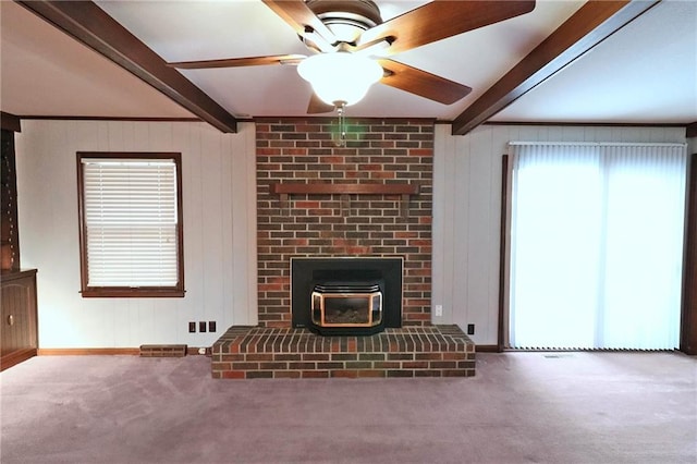 unfurnished living room featuring beamed ceiling, ceiling fan, and carpet floors