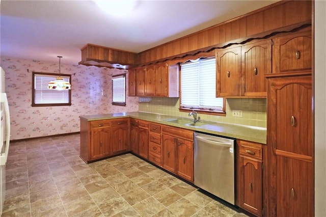 kitchen featuring hanging light fixtures, backsplash, sink, and dishwasher