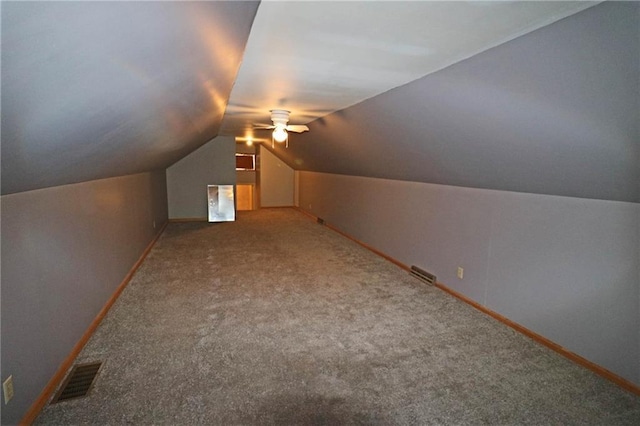 bonus room with vaulted ceiling, carpet, and ceiling fan