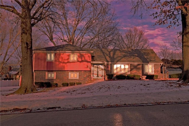 tri-level home featuring brick siding