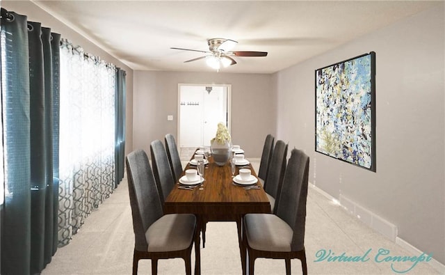 dining space featuring ceiling fan and baseboards