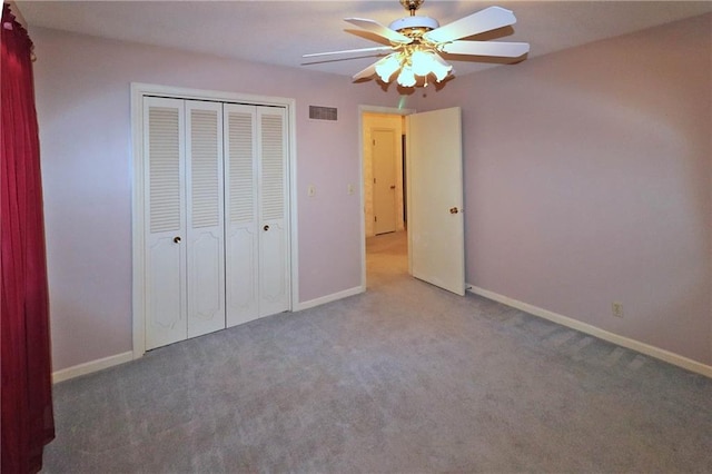 unfurnished bedroom with a closet, carpet flooring, and baseboards