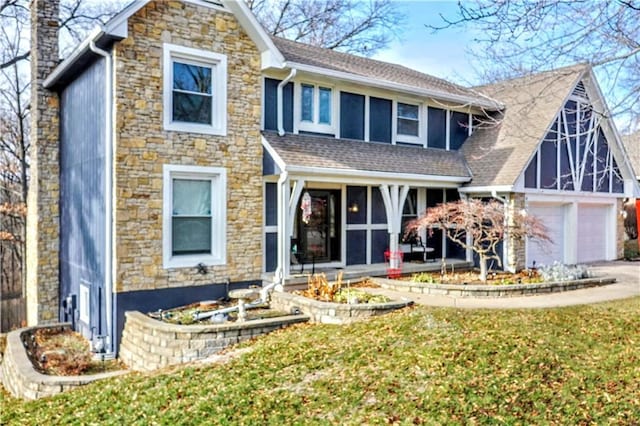 back of house with a garage and a yard