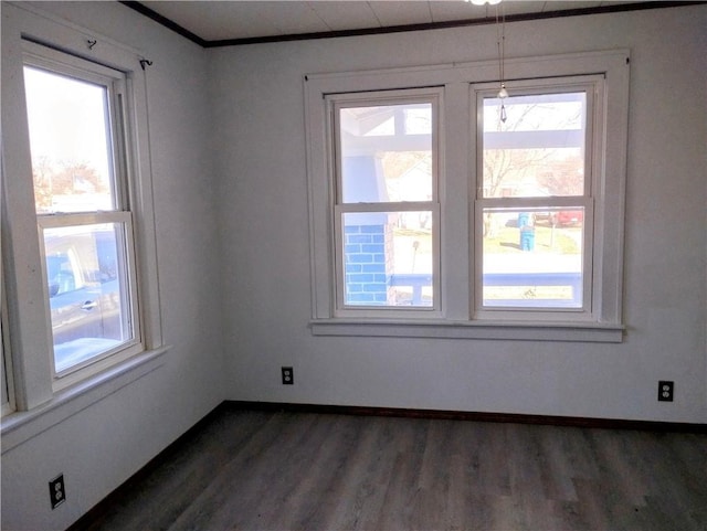 unfurnished room with dark hardwood / wood-style flooring and ornamental molding