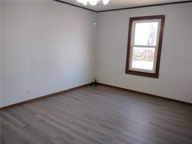 spare room with light hardwood / wood-style floors and ornamental molding