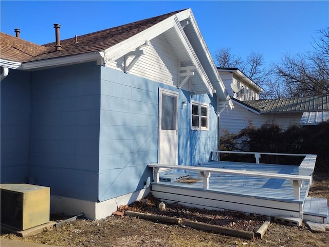 view of property exterior with a wooden deck