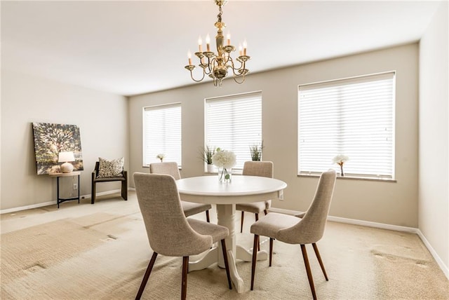 dining room featuring light colored carpet and a chandelier