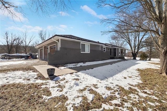 snow covered property with a garage