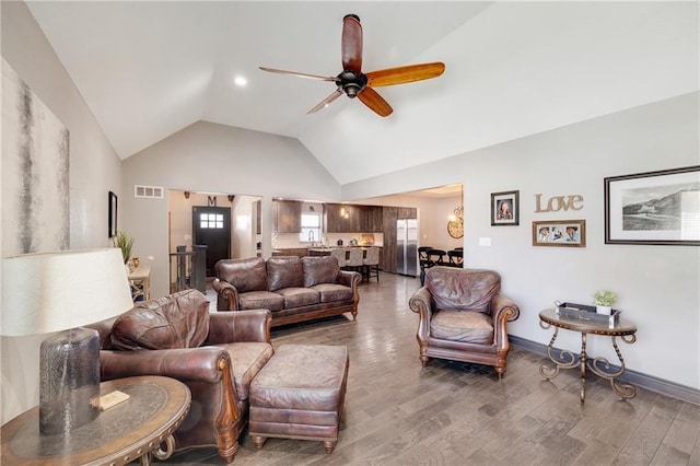 living room with lofted ceiling, wood-type flooring, and ceiling fan