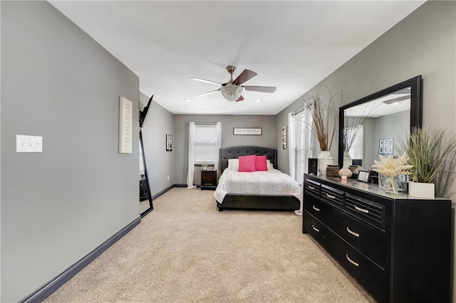 bedroom featuring ceiling fan and light carpet