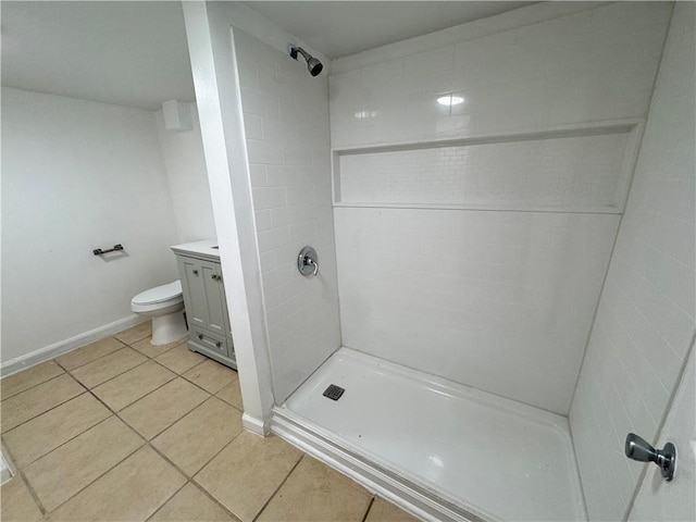 bathroom with a shower, tile patterned floors, vanity, and toilet