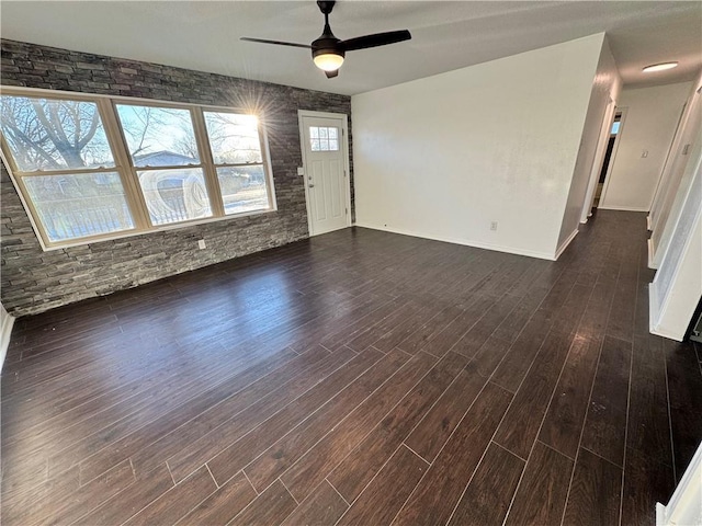 unfurnished living room with dark hardwood / wood-style floors and ceiling fan