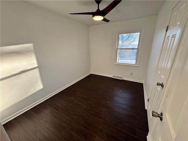 spare room with ceiling fan and dark hardwood / wood-style flooring