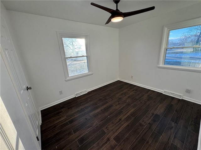 empty room with dark hardwood / wood-style floors and ceiling fan