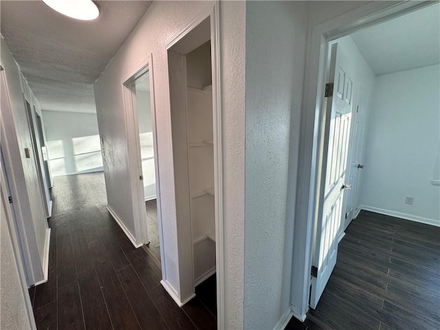 hallway with a textured ceiling