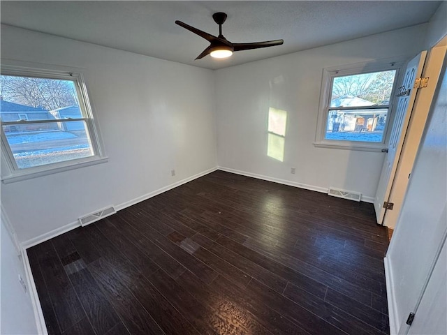 empty room featuring ceiling fan and dark hardwood / wood-style flooring