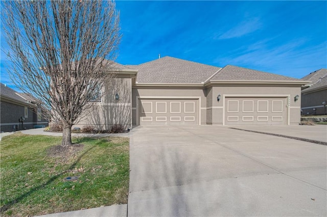 ranch-style house featuring a garage and a front lawn