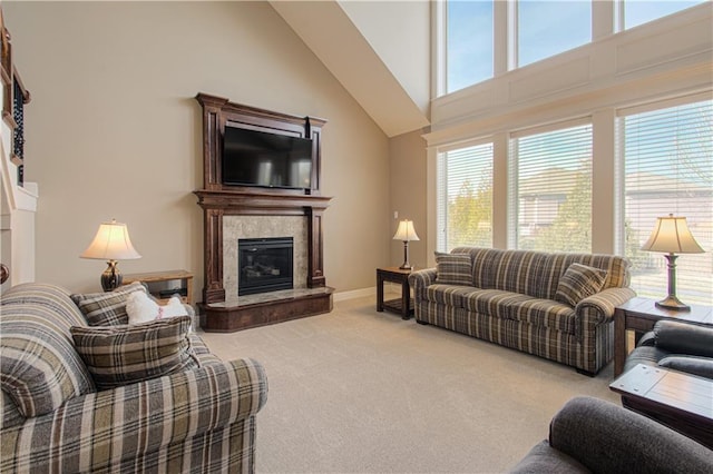 carpeted living room with high vaulted ceiling and a high end fireplace