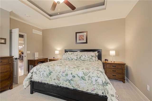 bedroom featuring light carpet, crown molding, a raised ceiling, and ceiling fan