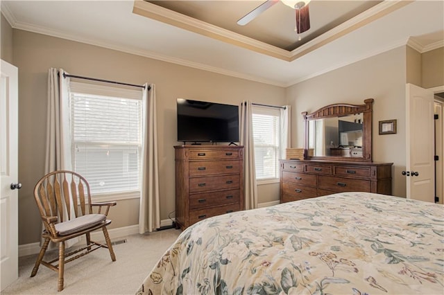 bedroom with ornamental molding, light colored carpet, a raised ceiling, and ceiling fan