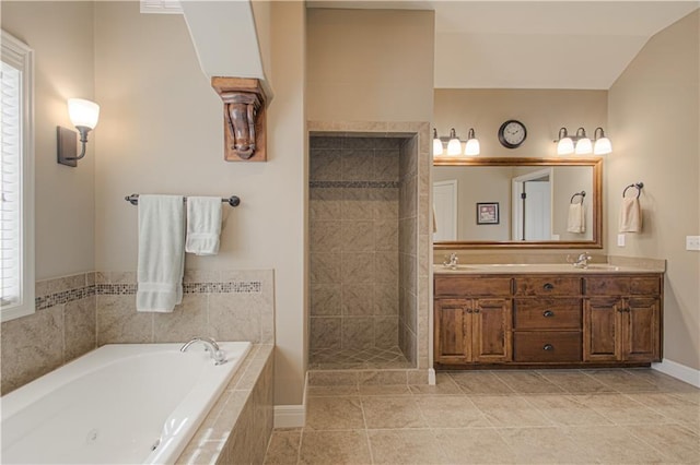 bathroom with independent shower and bath, vanity, and tile patterned floors