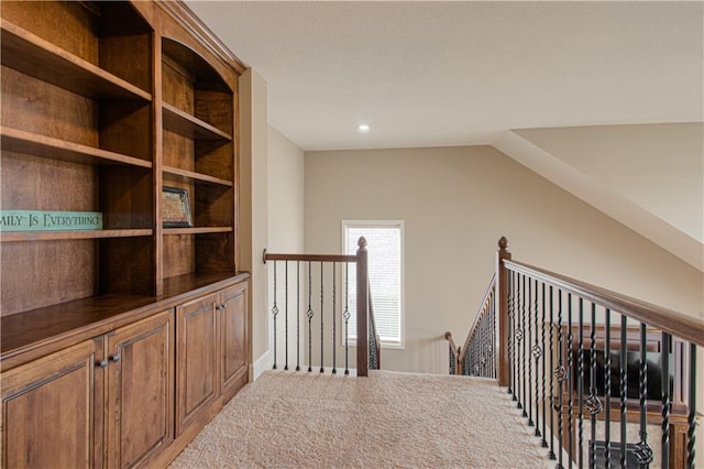 hall featuring vaulted ceiling