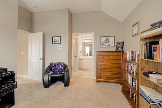 sitting room with vaulted ceiling and light carpet