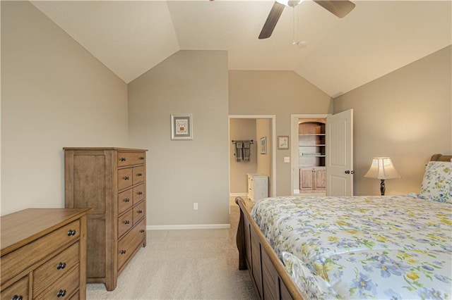 carpeted bedroom with lofted ceiling, connected bathroom, and ceiling fan