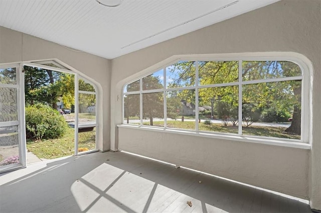 unfurnished sunroom featuring lofted ceiling