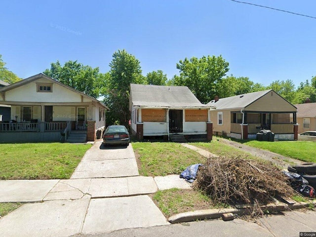 bungalow-style home with a front yard and a porch