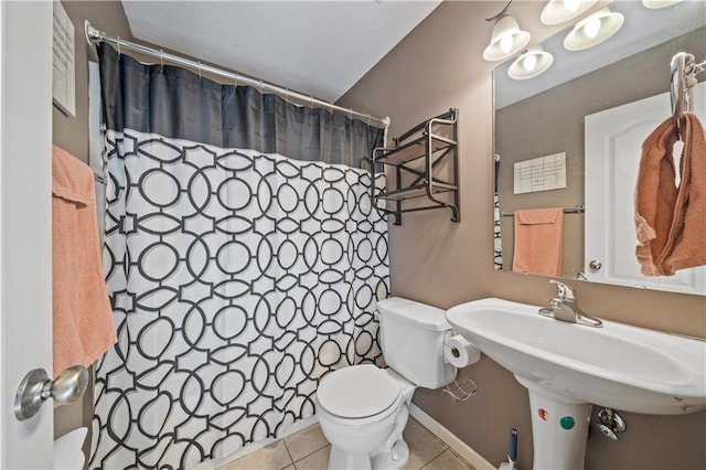 bathroom with sink, tile patterned floors, toilet, and a shower with shower curtain