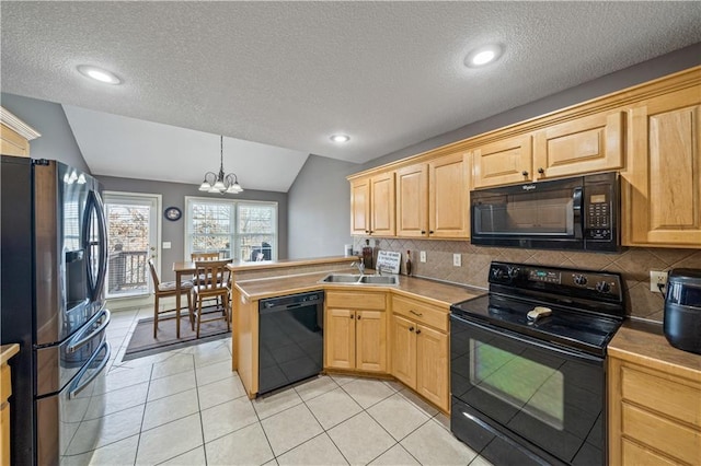 kitchen with vaulted ceiling, pendant lighting, sink, black appliances, and light brown cabinets