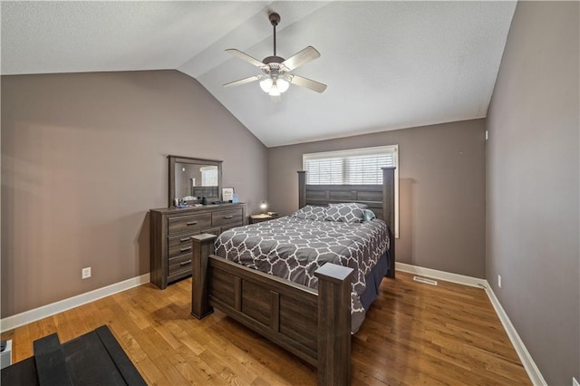 bedroom featuring vaulted ceiling, ceiling fan, and light wood-type flooring