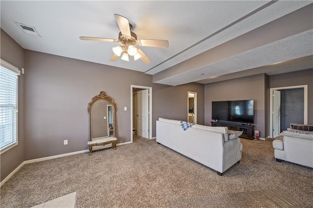 unfurnished living room with ceiling fan and carpet