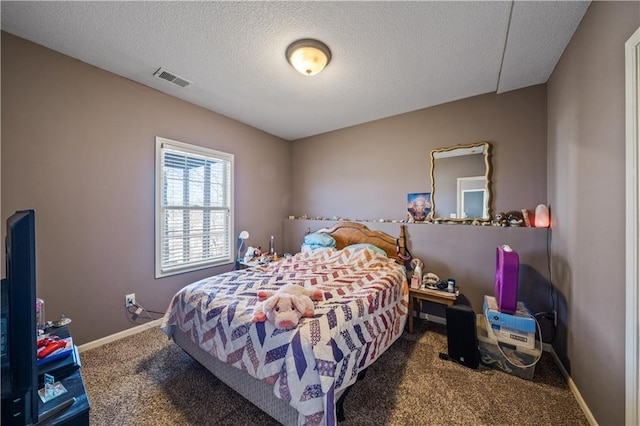 bedroom with carpet and a textured ceiling