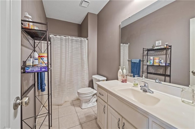 bathroom with tile patterned flooring, vanity, and toilet