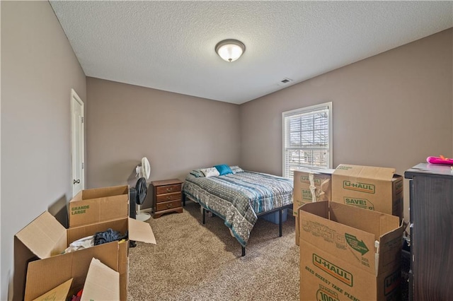 carpeted bedroom featuring a textured ceiling