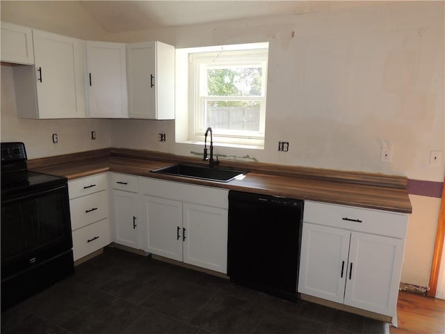 kitchen with white cabinets, a sink, wood counters, and black appliances