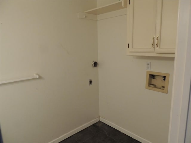 clothes washing area with washer hookup, cabinet space, electric dryer hookup, dark tile patterned floors, and baseboards