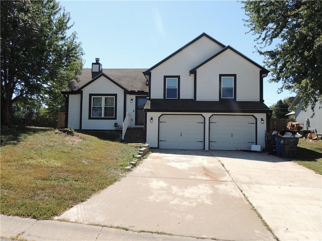 tri-level home featuring a garage, a chimney, concrete driveway, and a front lawn