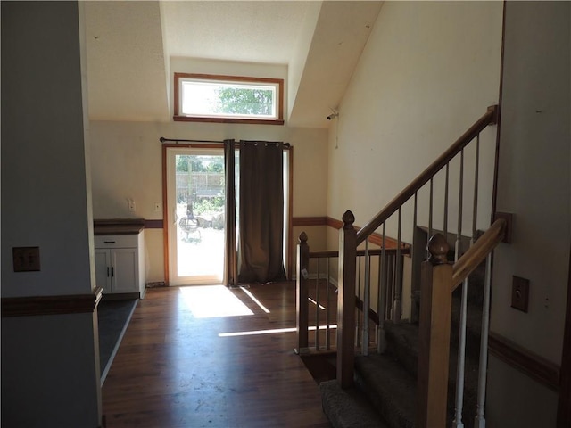 entrance foyer with dark wood finished floors and stairs