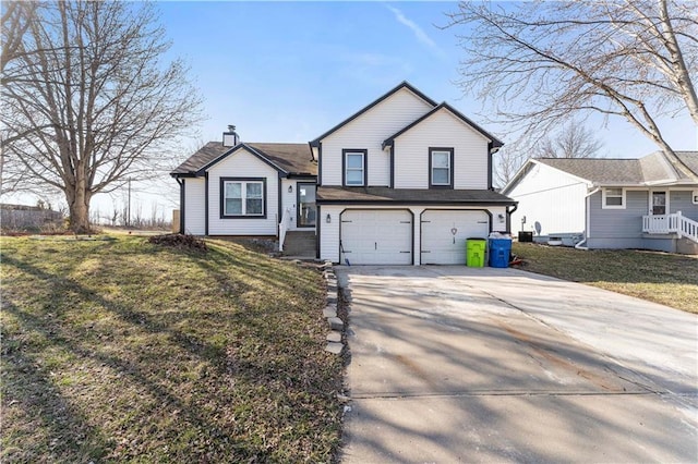 tri-level home with concrete driveway, an attached garage, and a front yard