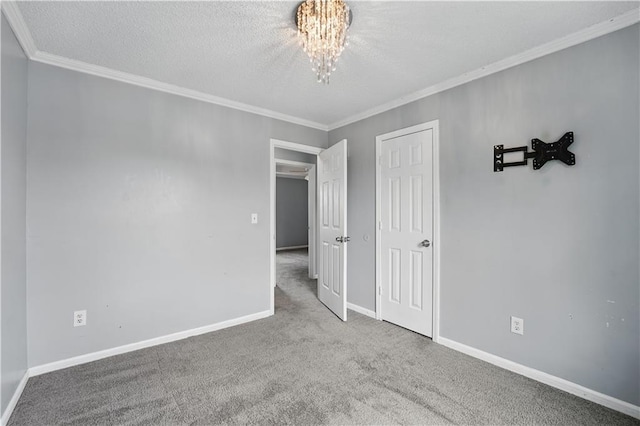 2016 NE Summerfield Ct, Blue Springs, MO 64029 - spare room with carpet flooring, a chandelier, crown molding, and a textured ceiling